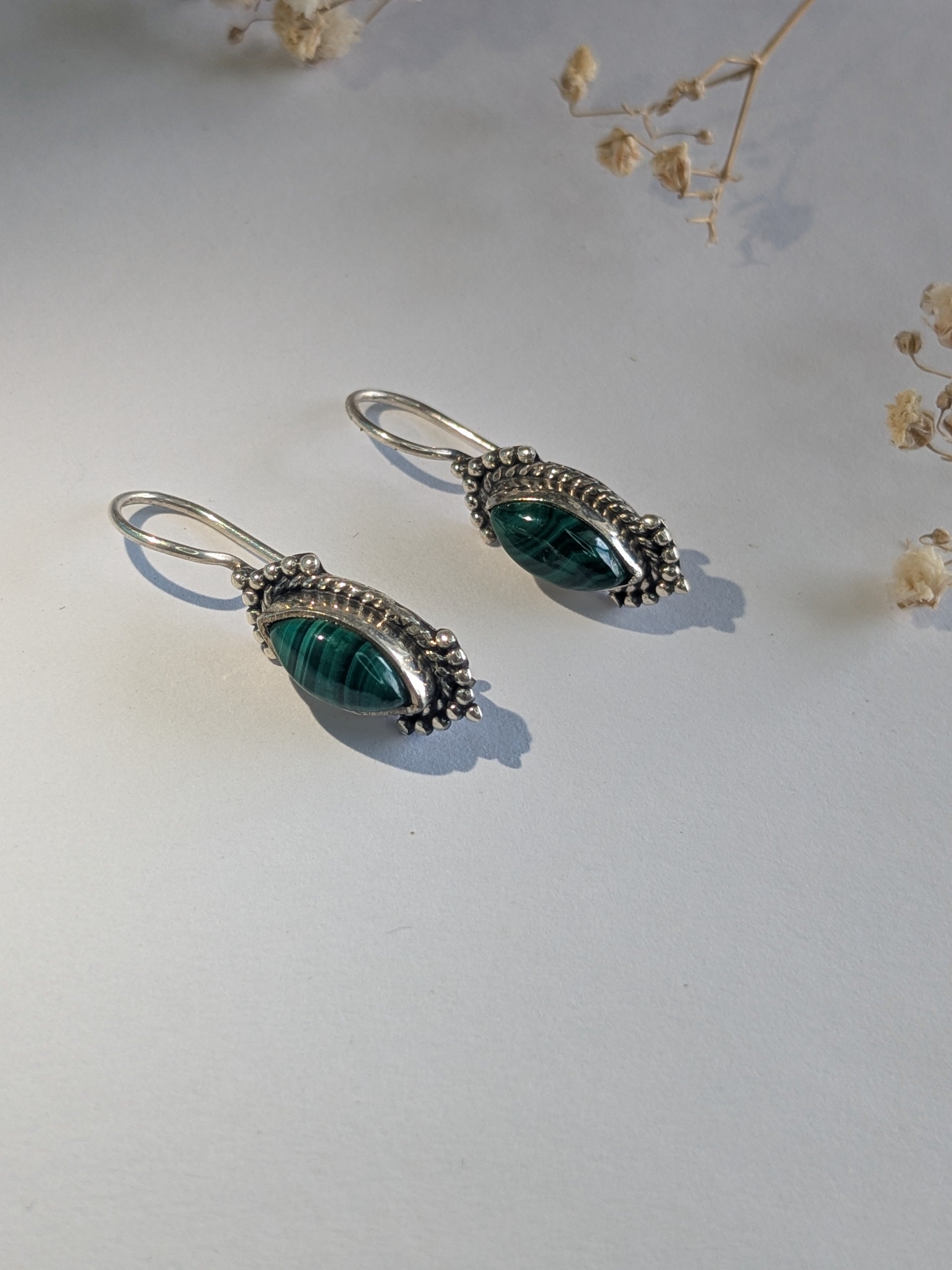 925 hallmarked silver earrings with green semi precious stone. Has secured clasp lock.